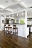 Modern home with Kitchen, Wine Cooler, Refrigerator, Range Hood, Range, Stone Counter, Microwave, Recessed Lighting, Dishwasher, Subway Tile Backsplashe, Wood Cabinet, White Cabinet, Open Cabinet, Ceiling Lighting, Medium Hardwood Floor, Undermount Sink, Metal Cabinet, Accent Lighting, and Pendant Lighting. Kitchen and bar at Residence 1414 by Miró Rivera Architects Photo 8 of Residence 1414