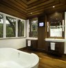 Modern home with Bath Room, Recessed Lighting, Medium Hardwood Floor, Wall Lighting, Open Shower, Accent Lighting, Freestanding Tub, Porcelain Tile Floor, Ceiling Lighting, One Piece Toilet, Pedestal Sink, and Stone Slab Wall. Master bath at Residence 1414 by Miró Rivera Architects Photo 10 of Residence 1414