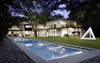 Modern home with Outdoor, Large Pools, Tubs, Shower, Lap Pools, Tubs, Shower, Back Yard, Swimming Pools, Tubs, Shower, Stone Patio, Porch, Deck, Large Patio, Porch, Deck, Landscape Lighting, Wood Fences, Wall, Walkways, Grass, Trees, Shrubs, Horizontal Fences, Wall, and Hardscapes. Back yard and lap pool at Residence 1414 by Miró Rivera Architects Photo 18 of Residence 1414