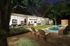 Modern home with Outdoor, Hardscapes, Lap Pools, Tubs, Shower, Walkways, Standard Construction Pools, Tubs, Shower, Gardens, Back Yard, Vertical Fences, Wall, Side Yard, Landscape Lighting, Concrete Pools, Tubs, Shower, Grass, Stone Patio, Porch, Deck, Trees, Large Pools, Tubs, Shower, and Small Patio, Porch, Deck. Back yard and lap pool at the 1917 Bungalow by Miró Rivera Architects Photo 10 of 1917 Bungalow