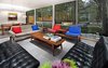 Modern home with Living Room, Porcelain Tile Floor, Sofa, Ceiling Lighting, Pendant Lighting, Chair, Coffee Tables, and End Tables. Living and dining rooms at the 1917 Bungalow by Miró Rivera Architects Photo 7 of 1917 Bungalow