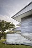 Modern home with Outdoor, Metal Fences, Wall, Shrubs, Grass, Walkways, Trees, Raised Planters, and Side Yard. The distinct sloped roof profiles provide directionality, essentially “pointing” to the views beyond. Photo 8 of Vista Residence