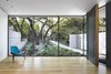 Modern home with Doors, Swing Door Type, Exterior, Wood, and Metal. The foyer blurs the line between interior and exterior, as the landscape seems to flow into the house through thin steel windows. White walls and white oak floors introduce the home’s warm material palette, while a nine-foot-tall pivot door made of white oak and painted aluminum greets visitors. Photo 2 of Vista Residence