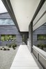 Modern home with Outdoor, Large Patio, Porch, Deck, Hardscapes, Garden, Gardens, Back Yard, Walkways, Pavers Patio, Porch, Deck, Concrete Fences, Wall, Shrubs, Landscape Lighting, Metal Fences, Wall, and Planters Patio, Porch, Deck. Exposed concrete, metal, and concrete panel cladding—chosen for their ease of maintenance—are the predominant materials. Photo 7 of Vista Residence