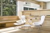 Modern home with Living Room, Recessed Lighting, Shelves, Ceiling Lighting, End Tables, Light Hardwood Floor, and Chair. The warmth of the kitchen spills over into the living area, where a cozy, daylit reading corner enjoys views into the adjacent oak canopies. Photo 15 of Vista Residence