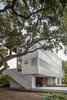 Modern home with Exterior, House Building Type, Flat RoofLine, Stucco Siding Material, and Metal Siding Material. The residence is divided into three levels in order to maximize views, with guest quarters at ground level, living spaces on the second floor, and the master suite at the highest level. Photo 3 of Edgecliff Residence
