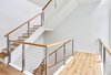 Modern home with Staircase, Wood Railing, Wood Tread, Cable Railing, and Metal Railing. Floating staircase behind a 32' glass wall. Photo 7 of Baker's Row