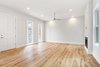 Modern home with Living Room, Ceiling Lighting, Light Hardwood Floor, Gas Burning Fireplace, and Two-Sided Fireplace. Streetfront unit living room with historical wood windows Photo 5 of Baker's Row