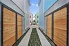 Modern home with Outdoor, Hardscapes, Landscape Lighting, Grass, and Wood Fences, Wall. Dwarf mondo driveway. Photo 6 of Baker's Row
