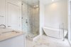 Modern home with Bath Room, Porcelain Tile Floor, Freestanding Tub, Drop In Sink, Granite Counter, Corner Shower, Full Shower, and Subway Tile Wall. Master Bathroom with historical wood windows Photo 9 of Baker's Row