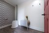 The interior was designed to feel like you walked through a portal into a home. We've had dozens of friends stay on the land and help with and collaborate on various projects; the least we can do is offer a hot shower, cold beer, and bathroom unlike any you'd expect to find when you hear "outhouse." Photo 2 of The Cube modern home