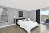 Modern home with Bedroom, Bed, Chair, Ceiling Lighting, Wall Lighting, and Concrete Floor. Master bedroom with polished concrete floors and private deck Photo 5 of Franklin Hills Modern