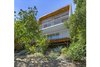 Modern home with Exterior, House Building Type, Wood Siding Material, and Stucco Siding Material. Back exterior features wood paneling details Photo 7 of Franklin Hills Modern