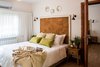Modern home with Bedroom, Bed, Night Stands, Wall Lighting, and Ceramic Tile Floor. The main sleepng area opens to the next room Photo 2 of Golden apple guest rooms