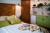 Modern home with Bedroom, Bed, Wall Lighting, and Ceramic Tile Floor. A view to the small kitchen Photo 4 of Golden apple guest rooms