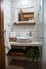 Modern home with Bath Room, Tile Counter, Ceramic Tile Floor, Corner Shower, Wall Lighting, One Piece Toilet, and Ceramic Tile Wall. The washroom Photo 12 of Golden apple guest rooms