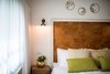 Modern home with Bedroom, Bed, Wall Lighting, and Ceramic Tile Floor. Apple decor above the bed headboard Photo 5 of Golden apple guest rooms