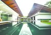 Modern home with Outdoor, Grass, Trees, Shrubs, Hardscapes, Gardens, Walkways, Flowers, Garden, Large Pools, Tubs, Shower, Swimming Pools, Tubs, Shower, Infinity Pools, Tubs, Shower, and Landscape Lighting. The planning follows the traditional Kerala architectural concept of the three block unit – "trishala", with a public and private zone separated by a swimming pool. The design encloses a swimming pool right in the center of the house which contributes to the aesthetics and at the same time helps in evaporative cooling thus influencing the micro climate of the area -- a truly desirable attraction in the hot humid climate of Kerala. The large overhangs provide good shading thereby moderating the direct impact of summer sun and monsoon storms. Photo 5 of The Flying House