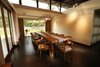 Modern home with Dining Room, Table, Chair, Lamps, Ceiling Lighting, Pendant Lighting, and Wall Lighting. The wall between the main entrance and the dining area has an attractive feature. Here acrylic rods have been inserted across the thickness of the wall. The two sides of the wall are covered with end faces of these rods. When there is a light source on one side of the wall the other side displays a dramatic effect of optical light play. Photo 7 of The Flying House