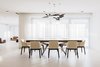 Modern home with Dining Room, Chair, Table, Ceiling Lighting, Pendant Lighting, Dark Hardwood Floor, and Porcelain Tile Floor. WH Residence | M3 Architects Photo 13 of WH Residence