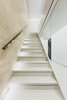 Modern home with Staircase, Concrete Tread, Stone Tread, and Glass Railing. WH Residence | M3 Architects Photo 16 of WH Residence