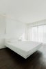 Modern home with Bedroom, Bed, Ceiling Lighting, Pendant Lighting, Dark Hardwood Floor, and Wall Lighting. WH Residence | M3 Architects Photo 17 of WH Residence