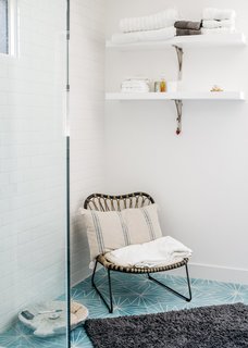 Dandelion cement tiles from Marrakech Design adorn the master bathroom. The chair is from Lawson Fenning. 