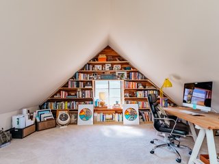 Upstairs attics and dormers are great home office ideas for small spaces. This unique home office design layout serves as both a small office and workout room for San Francisco–based knot artist Windy Chien. It also features clever storage space for the couple's voluminous collection of books.