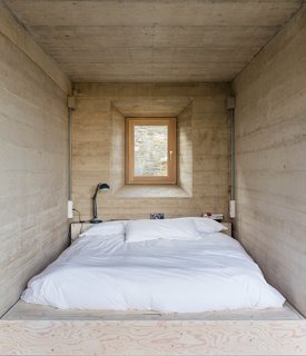 A cozy sleeping area illuminated by a dynamic faceted window. 