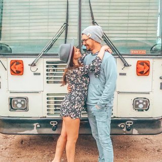 Chase and Mariajosé in front of their bus.