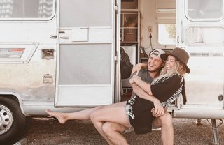 The Armstrongs cuddled up in front of their Airstream.