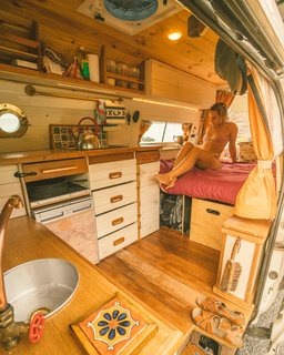 A view of the sink, kitchen, and bed. 