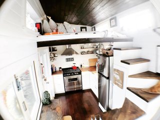 A view of the kitchen and sleeping loft. 