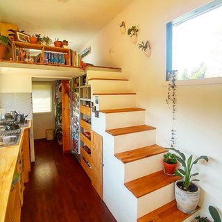 A view of the stairs and kitchen.