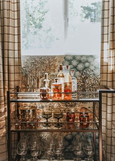 "I felt like an epic bar cart needed to make an appearance somewhere, and the den-like quality of the game room felt like just the place. I used the Brixton bar cart from Room & Board and filled it with some of my favorite vintage pieces as well as some new ones from West Elm. The copper Moscow Mule mugs are necessary for a cabin weekend."