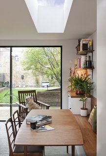 A skylight over the dining table creates an inviting gathering space. Furniture was sourced from London's Two Columbia Road.