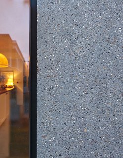 Cambridge Architectural Precast created a custom concrete with aggregate in yellow, orange, and brown tones selected to match London stock brick.