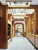 Modern home with Hallway, Terrazzo Floor, and Concrete Floor. A hallway of kiosks allows guests to easily check in, get key cards, and update reservations. Photo 2 of Sister City