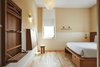 Modern home with Bedroom, Wall Lighting, Bed, Wardrobe, Lamps, Ceiling Lighting, Night Stands, Light Hardwood Floor, and Pendant Lighting. The rooms exude clean lines with all built in furniture aside for a stool. Photo 5 of Sister City
