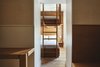 Modern home with Bedroom, Light Hardwood Floor, Bed, Wall Lighting, Bunks, and Night Stands. Certain rooms have bunk beds to accommodate groups or families. Photo 6 of Sister City