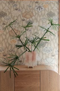 Muted, floral wallpaper adorns the walls. 