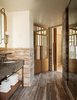 Modern home with Bath Room, Drop In Sink, Marble Counter, Stone Counter, Wall Lighting, Stone Slab Wall, and Limestone Floor. The Zen-like bathrooms are cloaked in stone and wood. Photo 8 of Santa Monica Proper