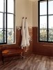 Modern home with Bath Room, Ceramic Tile Wall, and Limestone Floor. Rust-hued tile provides a pop of color against the onyx windows and bench legs. Photo 9 of Santa Monica Proper