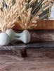 Modern home with Bath Room, Stone Counter, and Limestone Floor. A vase filled with fluffy reeds lends a bit of softness to the stone bathroom. Photo 10 of Santa Monica Proper