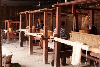 An array of looms allows weavers to work in tandem.