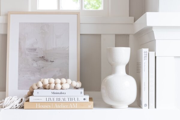 Decor will shift by mood, season, or event. Seen here is an art piece from Juniper Print Shop Tasseled and wooden beads from Saffron and Poe.