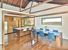 Modern home with Dining Room, Table, Stools, and Dark Hardwood Floor. Kitchen/Dining Area with sliding window closed Photo 5 of Fenlon House