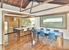 Modern home with Dining Room, Dark Hardwood Floor, Table, and Stools. Kitchen/Dining Area with sliding window open Photo 6 of Fenlon House