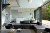 Modern home with Chair, Sofa, Coffee Tables, Ceiling Lighting, Floor Lighting, Pendant Lighting, Concrete Floor, Windows, Sliding Window Type, and Metal. The living room Photo 3 of Biscuit House