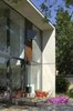 Modern home with Back Yard, Field, Small Patio, Porch, Deck, Wood Patio, Porch, Deck, House Building Type, Concrete Siding Material, Metal Siding Material, Wood Siding Material, Windows, Metal, and Sliding Window Type. the concrete hull Photo 4 of Seven